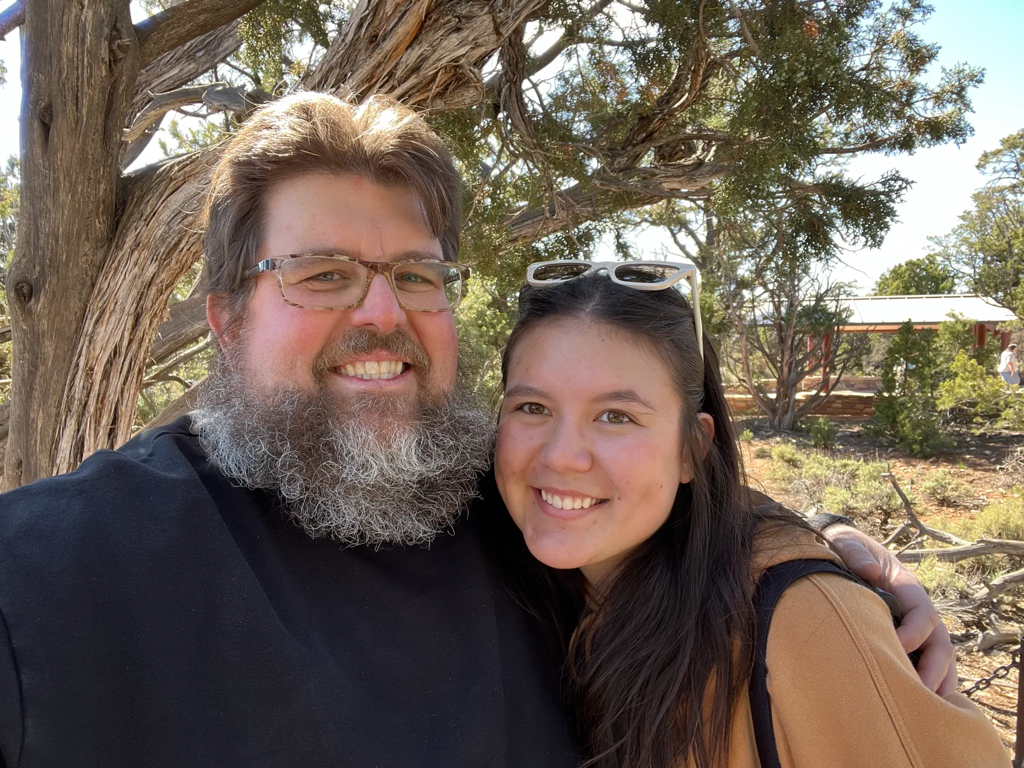 Rob and Morgan outdoors under a tree